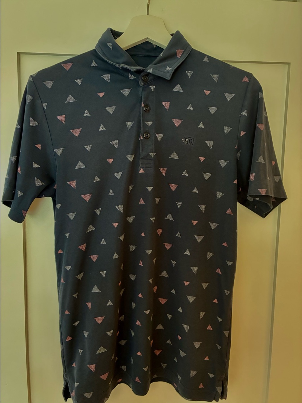 Travis Mathew Navy Polo with Pink & Light Gray Triangle Print